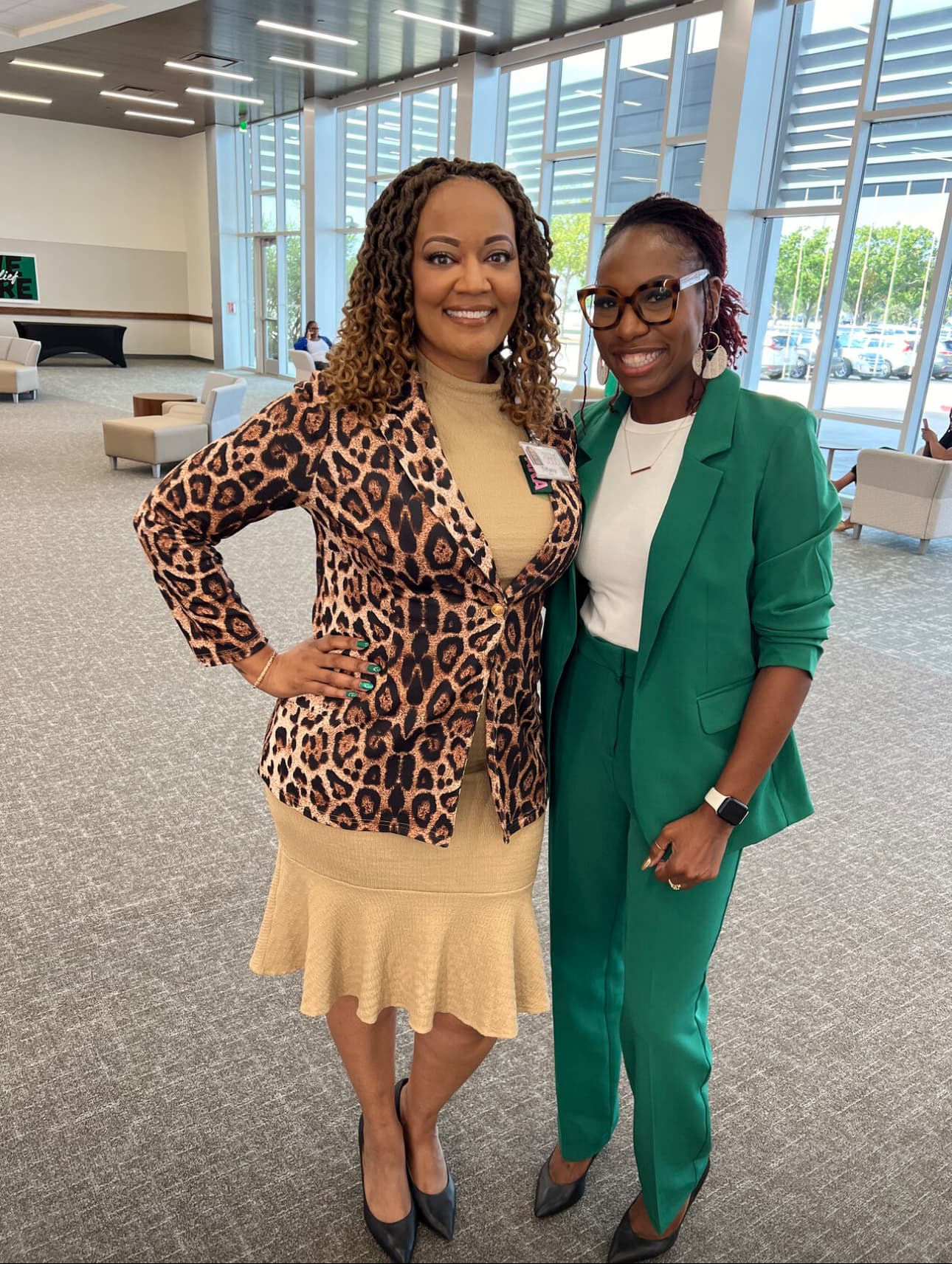 Dr. Natalie Edwards-Hudson posing with a colleague in a bright office lobby