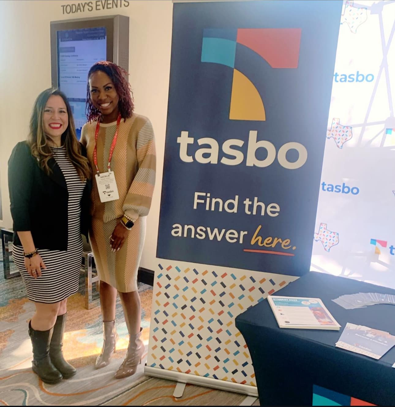 Dr. Natalie Edwards-Hudson posing with a colleague in a conference center lobby